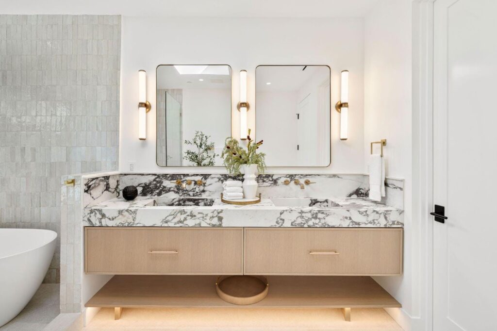 A luxurious bathroom featuring elegant marble countertops and a pristine white bathtub