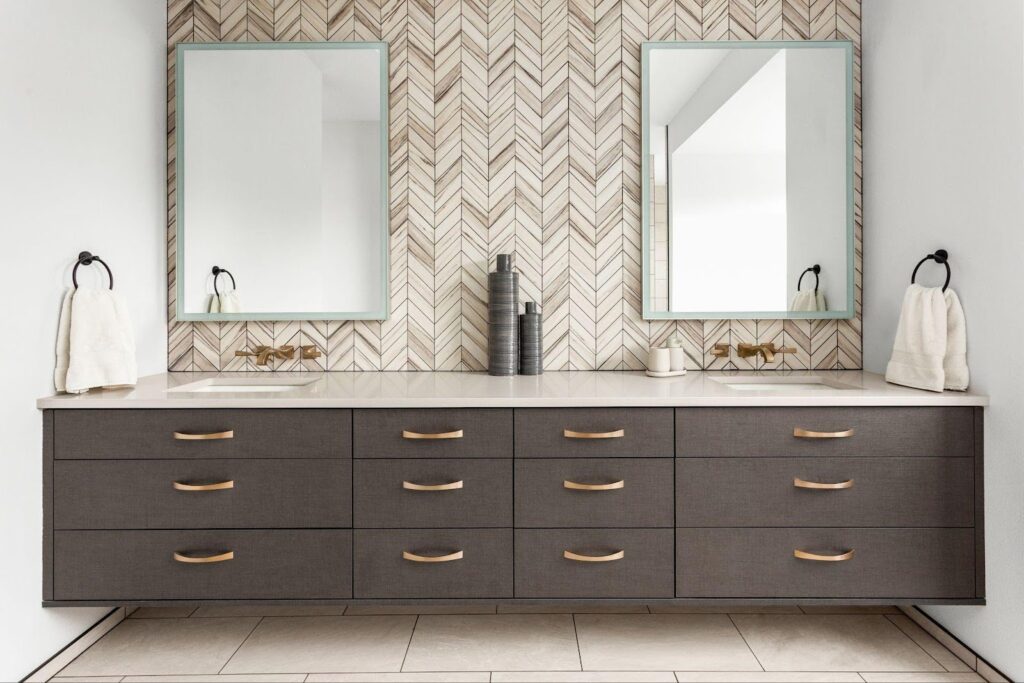 A spacious bathroom showcasing a double sink and a wide mirror designed for functionality and elegance