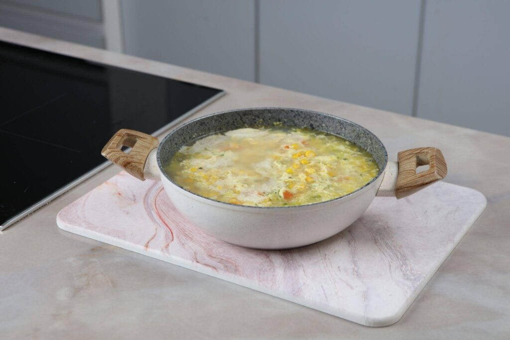 A bowl of soup placed on a polished marble counter showcasing its rich color and texture