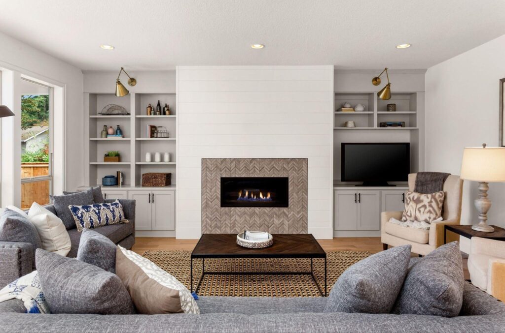 A stylish living room with a fireplace two inviting couches and decorative elements creating a warm relaxing space