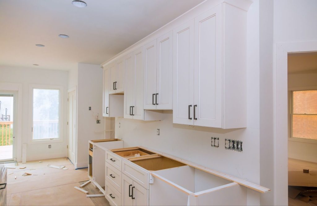 White custom cabinets and countertops in a kitchen remodel with modern design
