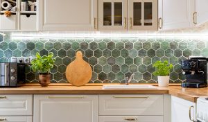 Modern Kitchen With Green Tile Wall And White Counter, Featuring Sleek Kitchen Cabinets