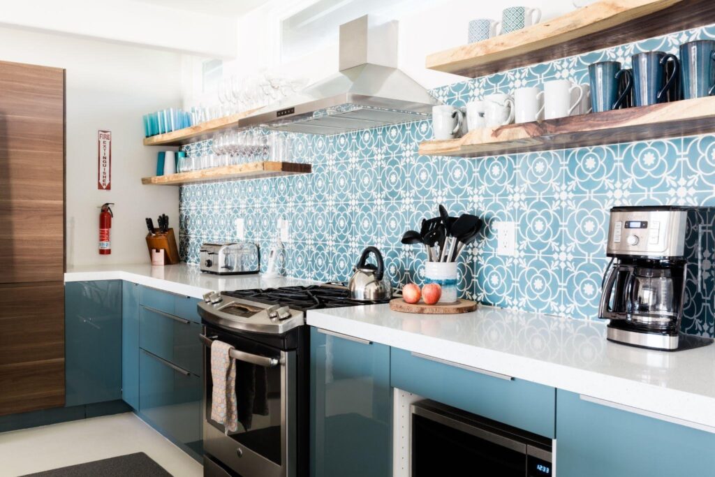 A bright kitchen adorned with blue and white tiles showcasing a stylish and contemporary design
