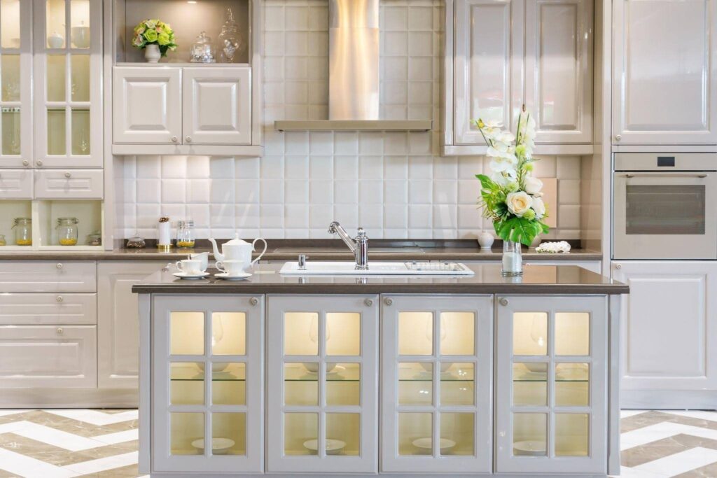 Bright kitchen featuring white cabinetry and a chevron patterned wall