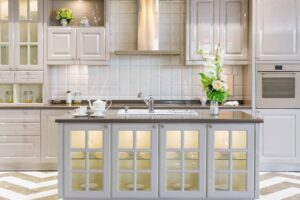 Bright kitchen featuring white cabinetry and a chevron patterned wall