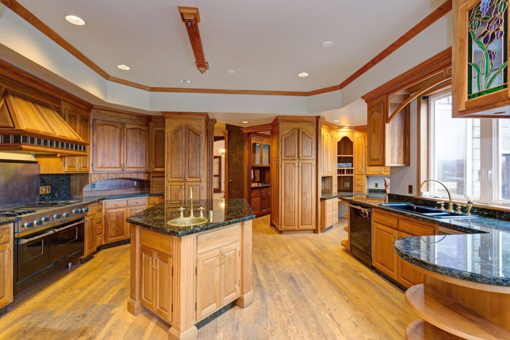 A large kitchen with rich wood cabinetry and sleek granite countertops.