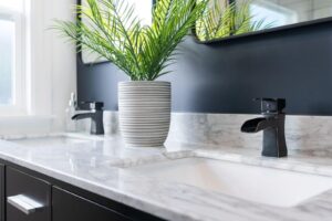 A modern bathroom with elegant black and white marble countertops