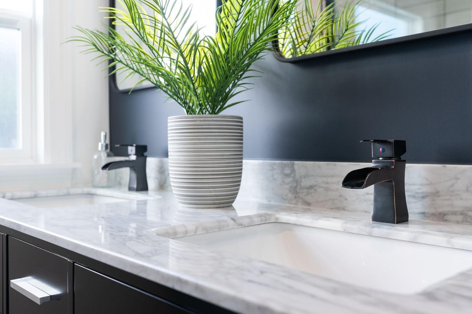 A modern bathroom with elegant black and white marble countertops