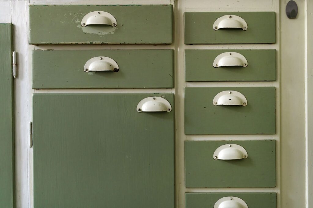Vintage green drawers with white handles.