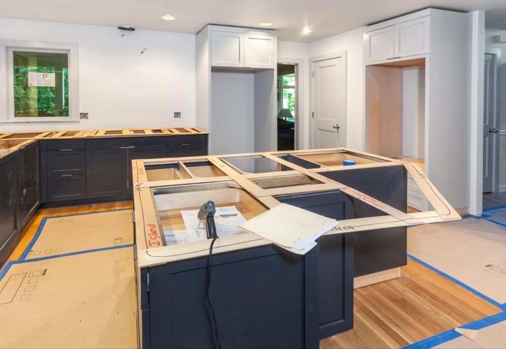 A modern kitchen featuring blue cabinets and warm wood floors creating a stylish and inviting atmosphere