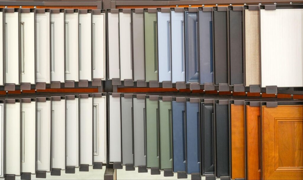 A display of various colored doors and windows arranged on a rack showcasing different styles and designs