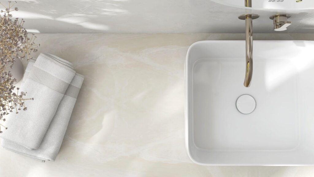 Bathroom sink with a sleek white marble countertop featuring modern fixtures and a stylish design