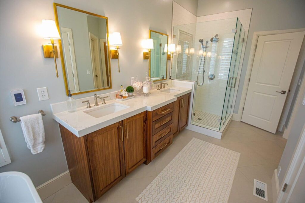 A modern bathroom featuring two sinks and a spacious shower area