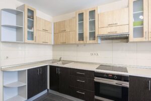 A modern kitchen with a sink stove and cabinets showcasing an organized cooking space