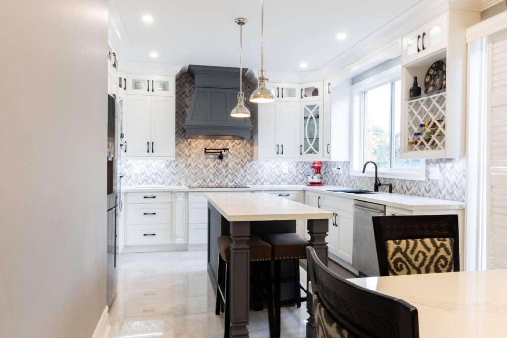 A modern kitchen with white cabinets and a sleek black island creating a stylish contrast